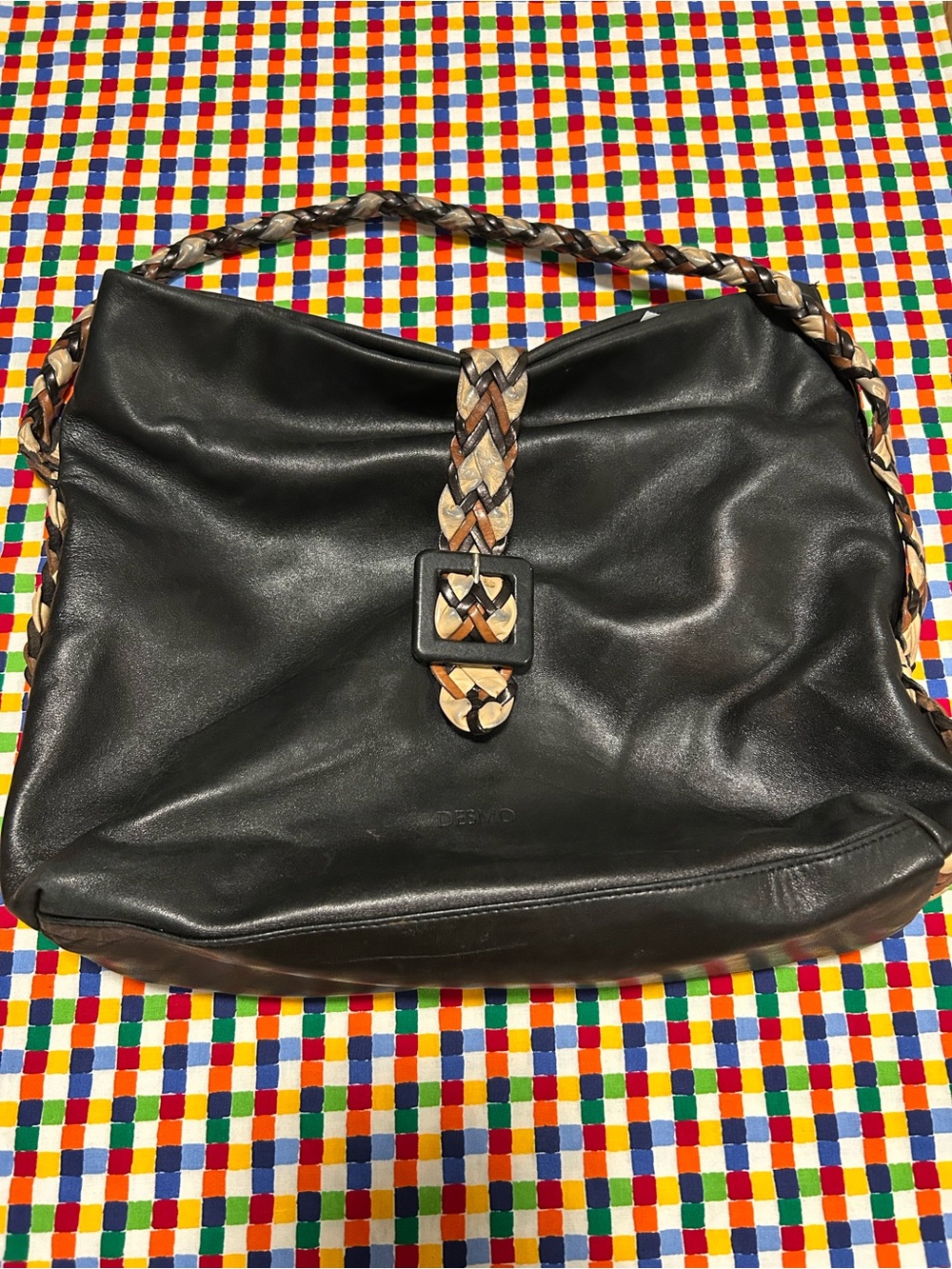 Desmo genuine leather satchel features a braided strap and buckle detail